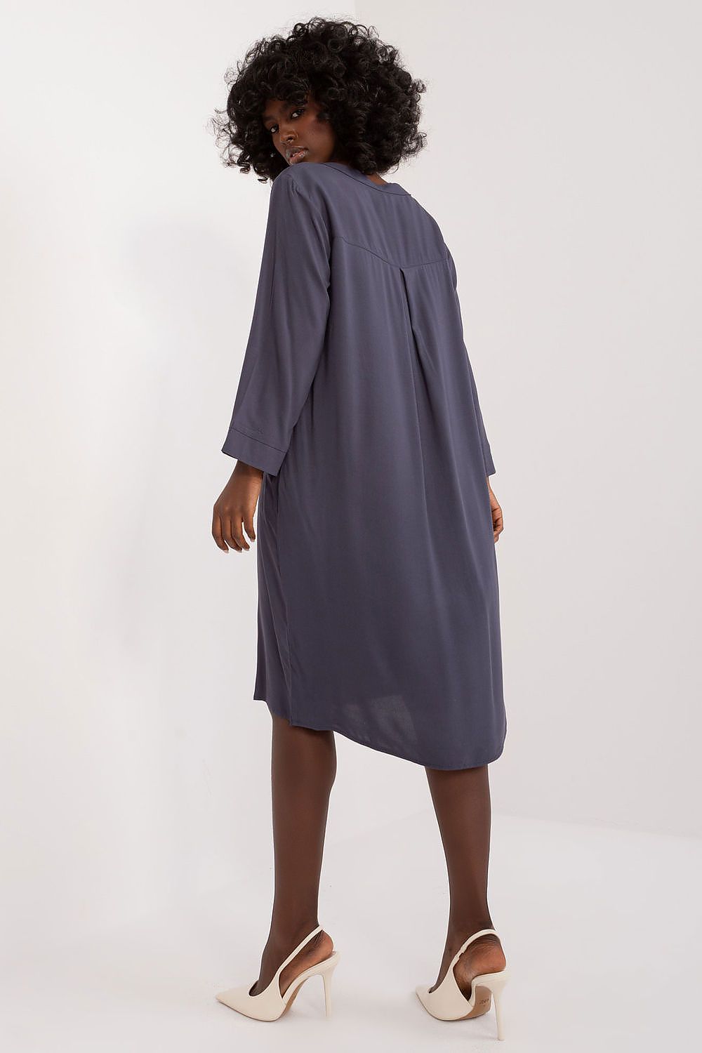 Elegant oversized V-neck daydress by Sublevel displayed on a hanger, showcasing its sophisticated style and versatility for various occasions.