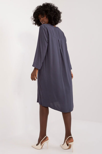 Elegant oversized V-neck daydress by Sublevel displayed on a hanger, showcasing its sophisticated style and versatility for various occasions.