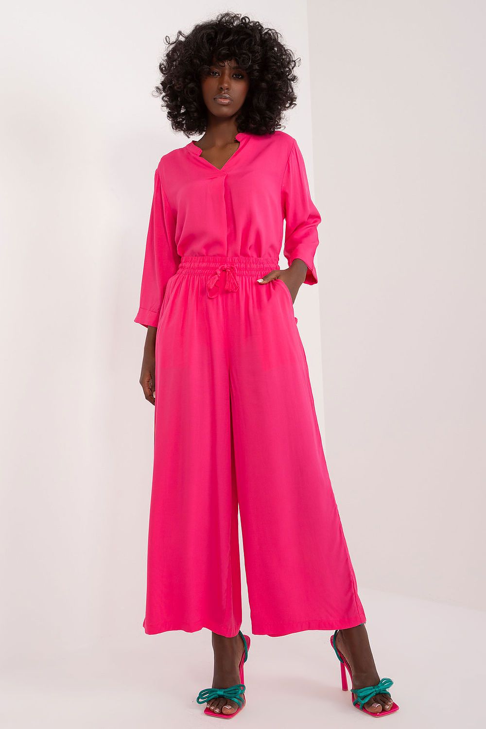 Stylish Sublevel palazzo pants with practical side pockets, perfect for an elegant yet comfortable outfit.