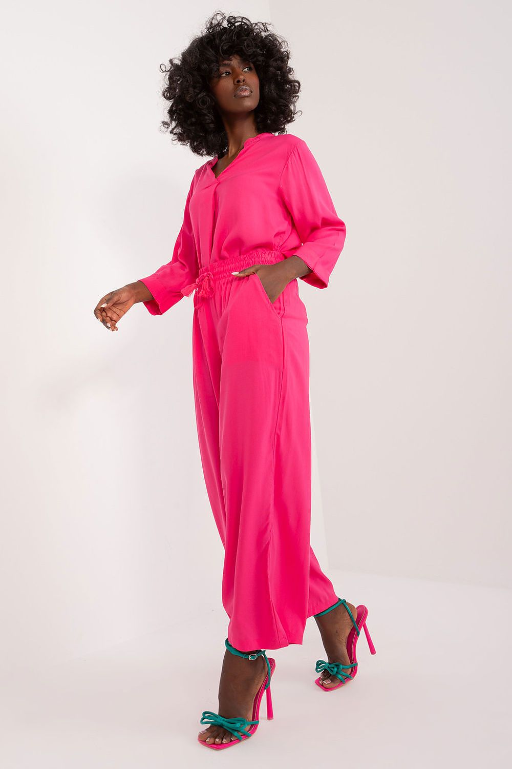 Model wearing Sublevel elegant women's palazzo pants, demonstrating a flattering high rise fit and chic casual style.