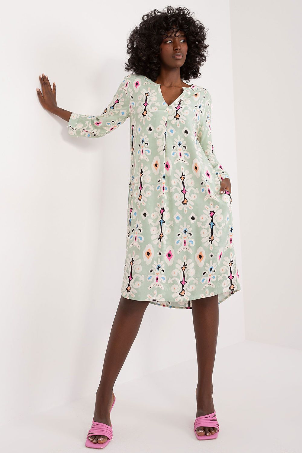 Sublevel oversized day dress in soft viscose featuring long sleeves, V-neck, decorative flap, and practical side pockets, perfect for stylish everyday wear.