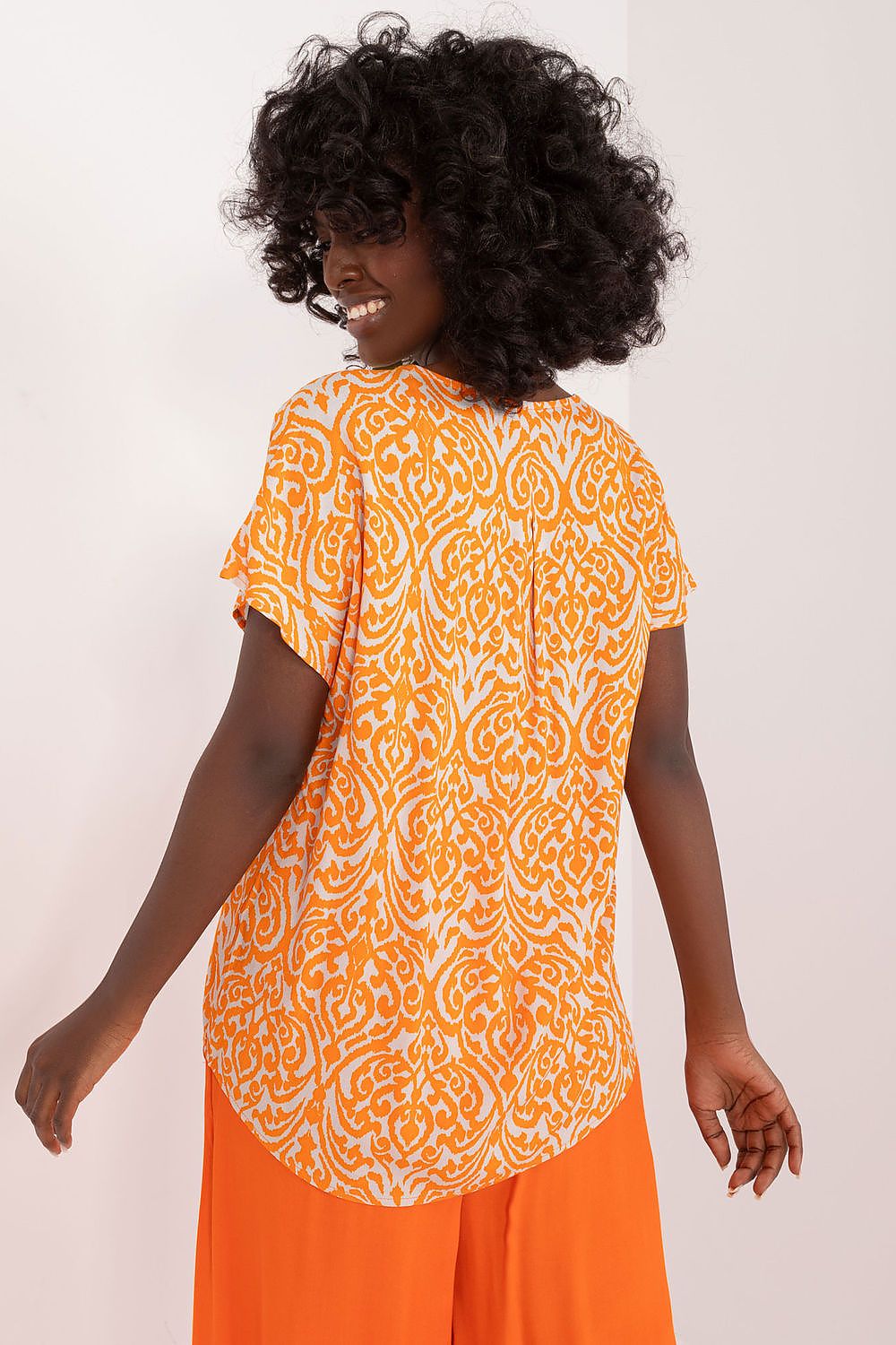 The full view of Sublevel's chic printed blouse, featuring short sleeves and a perfect standard length, styled with versatile bottoms for effortless and sophisticated daily outfits.