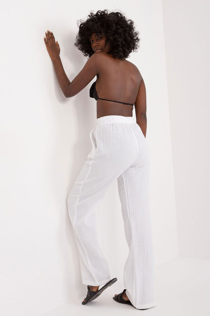 Model wearing Sublevel luxury women's high waist cotton trousers in a casual setting, highlighting stylish slip pockets and sophisticated cut.