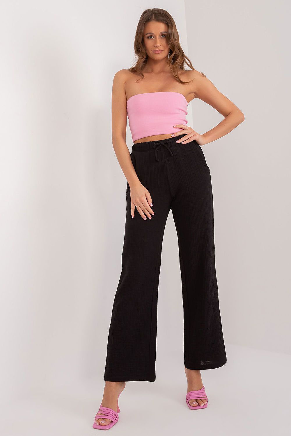 Flat lay of Sublevel luxury women's high waist cotton trousers, emphasising the smooth solid-colour fabric and versatile design.