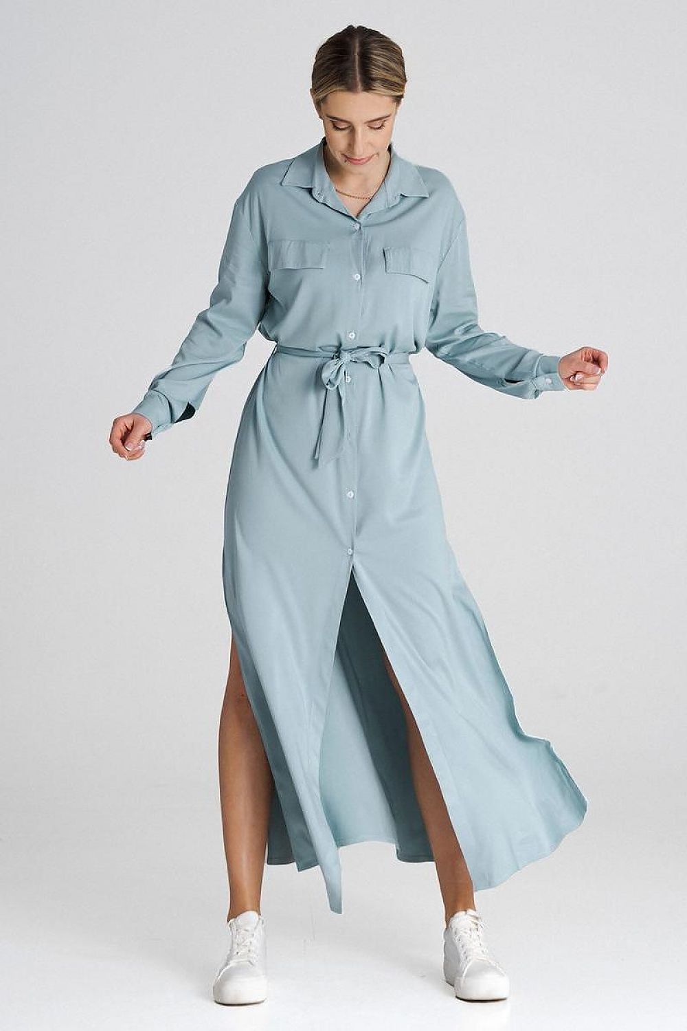 Close-up of the Figl maxi shirt dress showcasing the decorative flaps on the bust line and waist tie for a chic look.