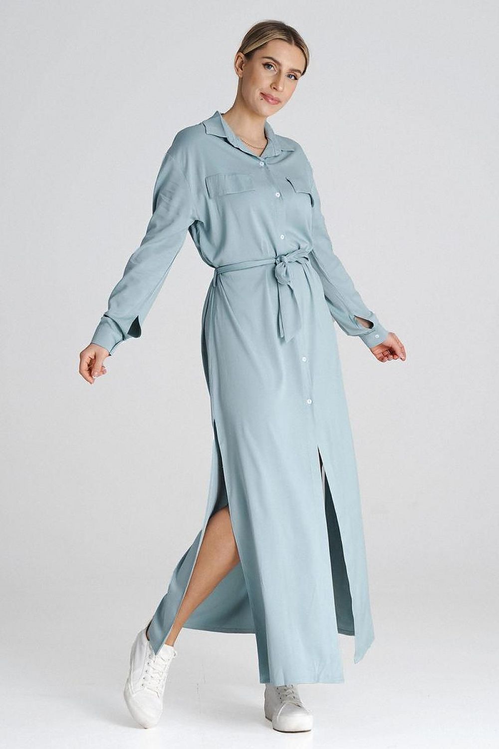 Side view of the Figl maxi shirt dress highlighting the long button-up style and elegant silhouette with side slits.