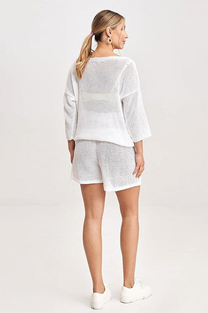 Chic Figl blouse from a two-piece set, showcasing intricate knitted front inserts and 3/4 sleeves, perfect for stylish outings.