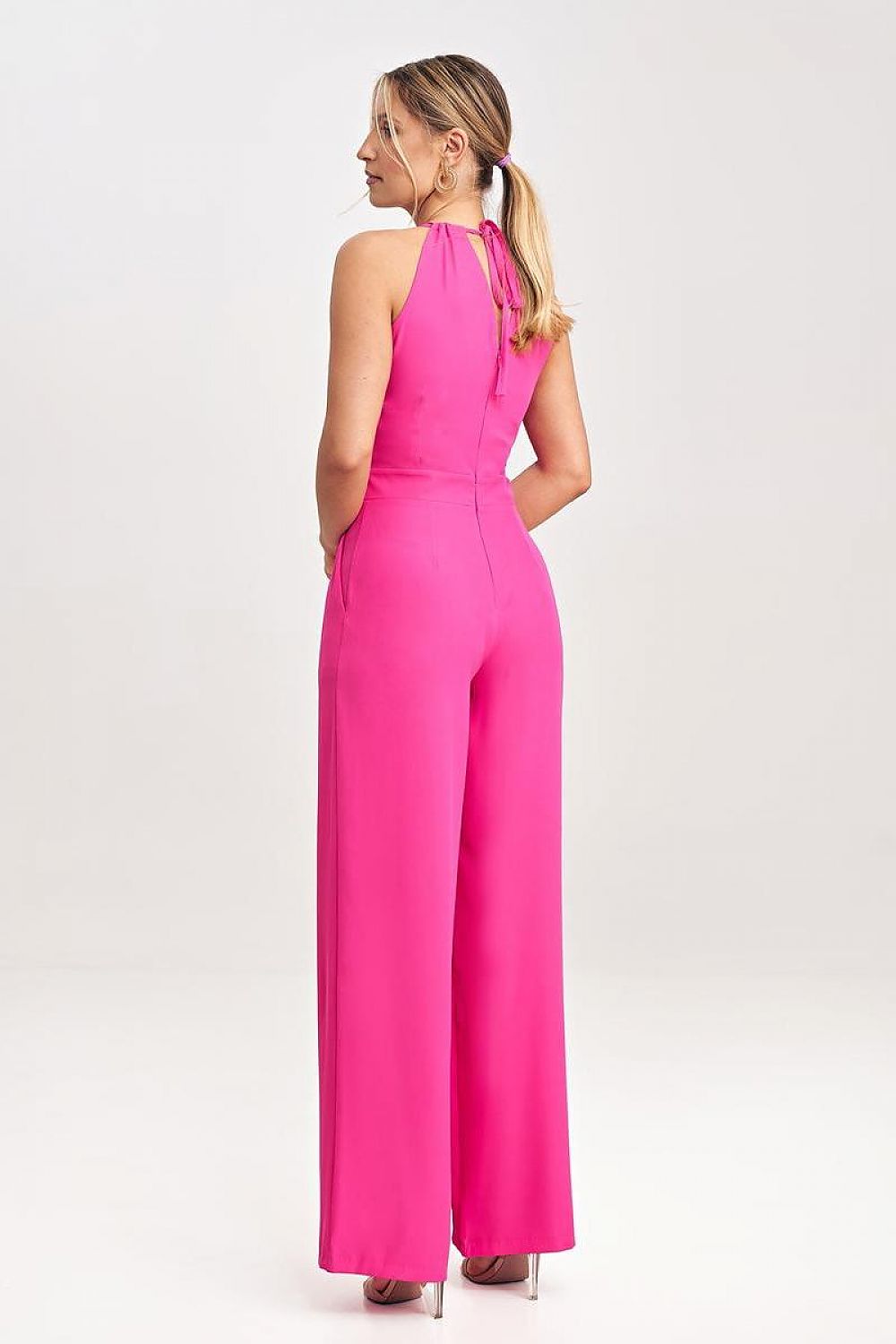 Chic sleeveless jumpsuit by Figl with practical pockets and refined tied neck detail.