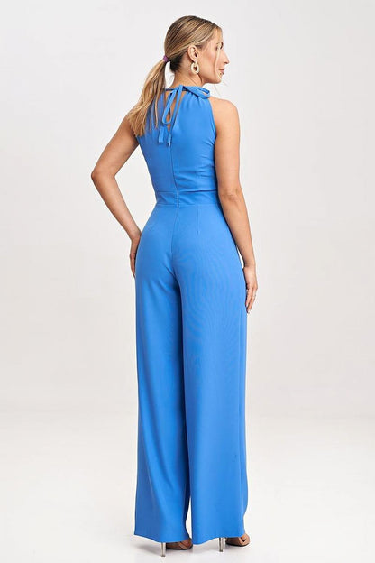 Elegant sleeveless jumpsuit by Figl featuring a tied neck and luxurious slip pockets, styled on a model.