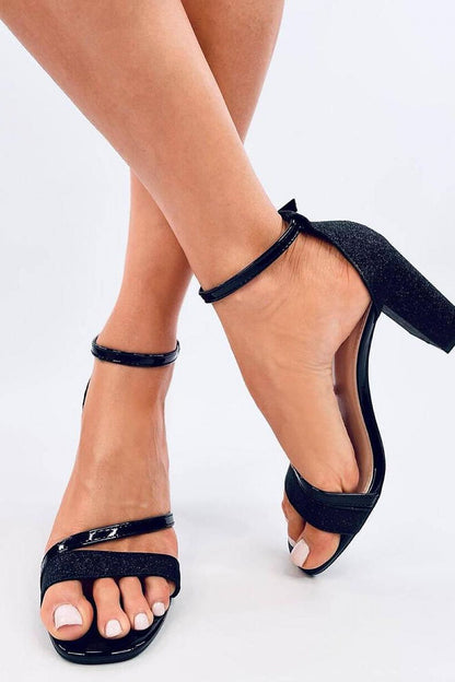 Close-up view of Inello's stylish women's block heel sandals featuring a shimmering glitter design and sleek patent straps, ideal for adding elegance to your outfit.