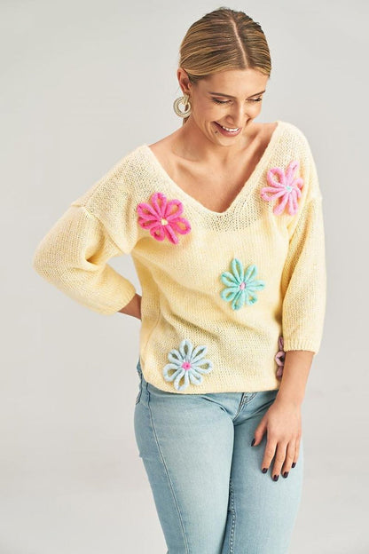 Close-up view of the Luxury Figl Floral Detail V-Neck Sweater, featuring intricate flower decorations and luxurious fabric blend, perfect for sophisticated fashion.