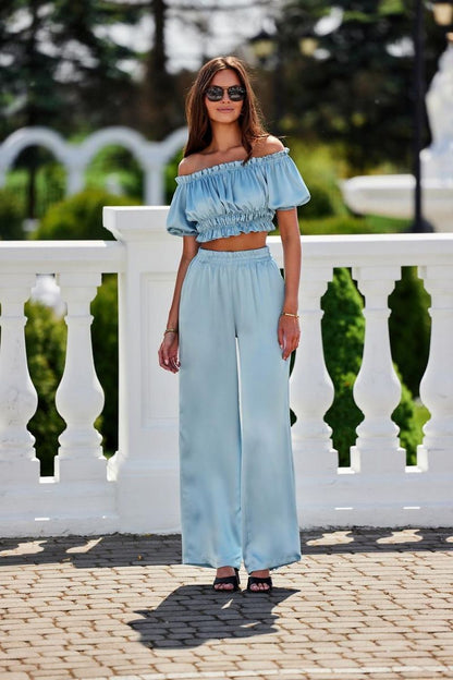 Elegant luxury satin trousers by Roco Fashion, featuring a comfortable elastic waistband and flared legs, perfect for sophisticated styling at formal occasions.