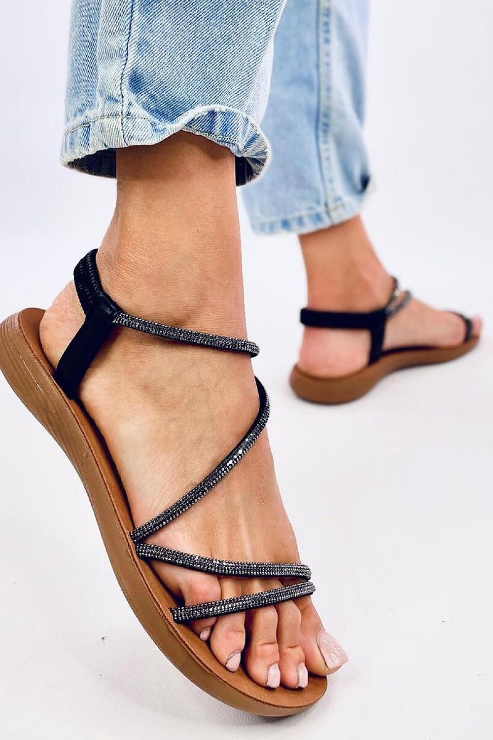 Chic and comfortable women's flat sandals from Inello, designed with exquisite cubic zirconia detailing on synthetic leather straps, perfect for elevating your summer outfits.