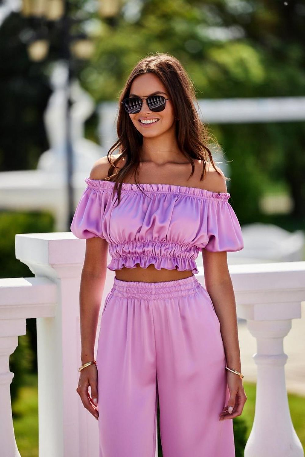 A model wearing the Marbella satin blouse by Roco Fashion, exemplifying casual elegance for outings or special events.