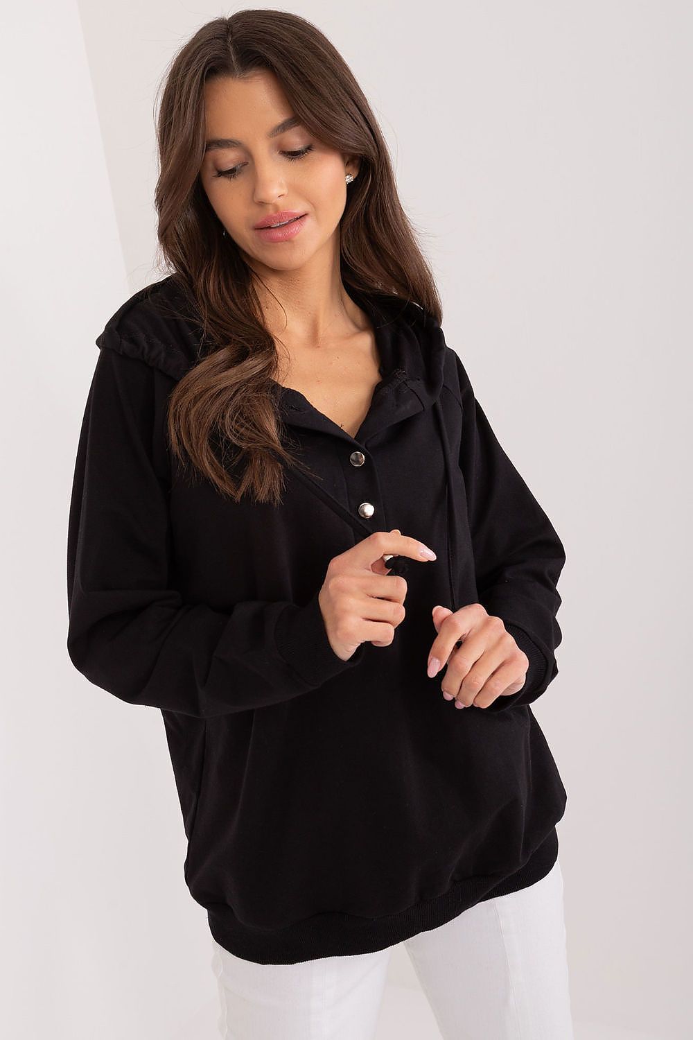 Relevance women's hoodie showcasing an adjustable fit with buttons and drawstring, designed for comfort and a sporty aesthetic.