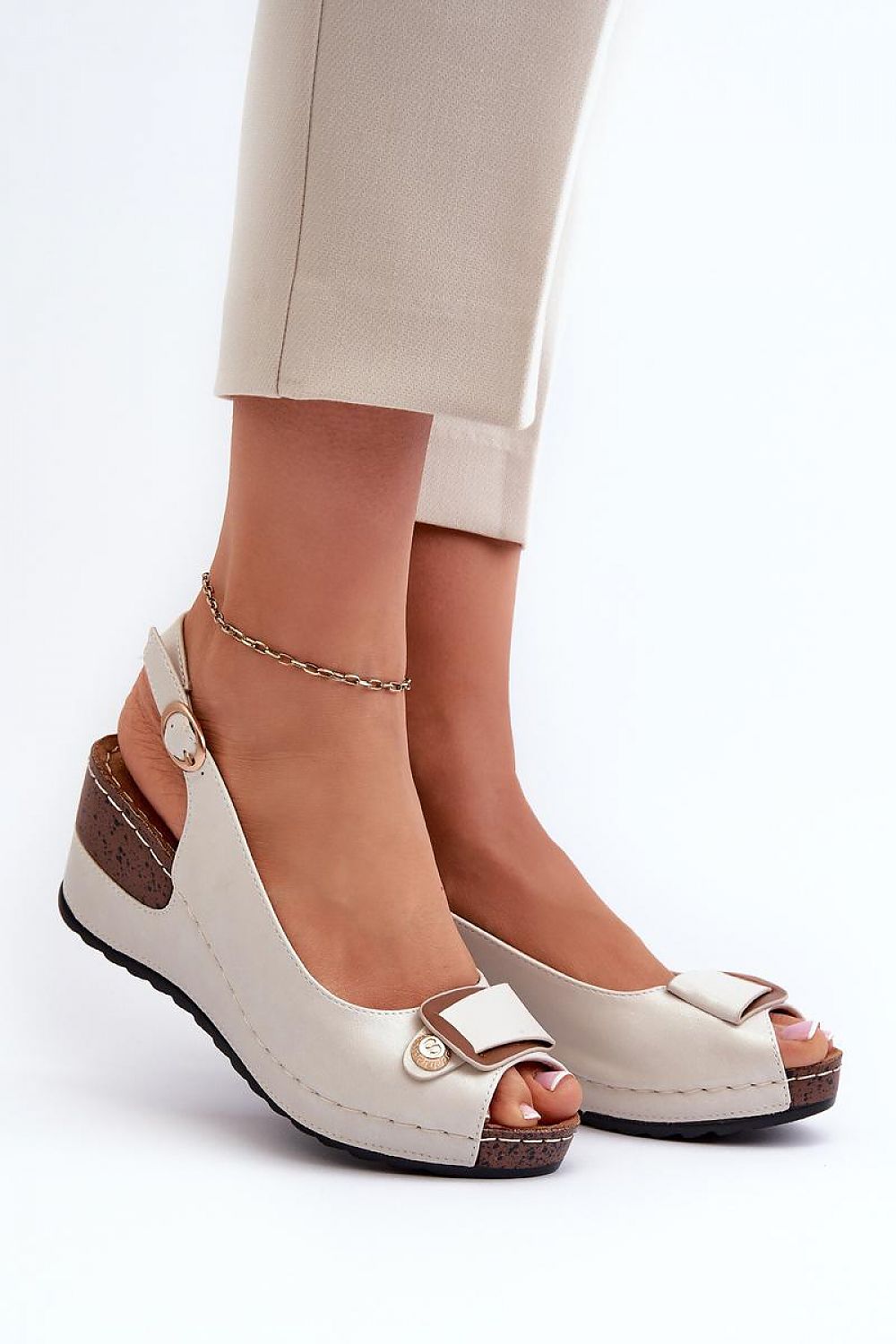 Close-up of Step in Style eco leather wedge sandals, showcasing the intricately designed adjustable buckle strap and luxurious cushioning for ultimate comfort.