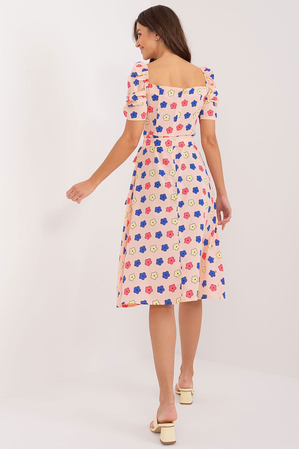 Side view of Lakerta's floral fit-and-flare summer dress showcasing its flattering knee-length design and lightweight puff sleeves.