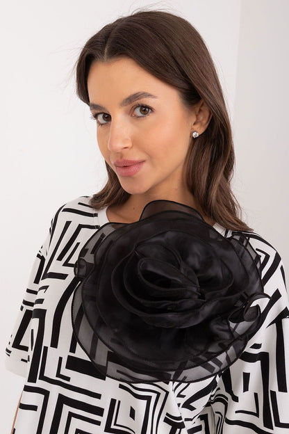Close-up of Lakerta's stylish viscose blouse showcasing the fabric flower brooch and intricate geometric design, ideal for a luxurious everyday look.