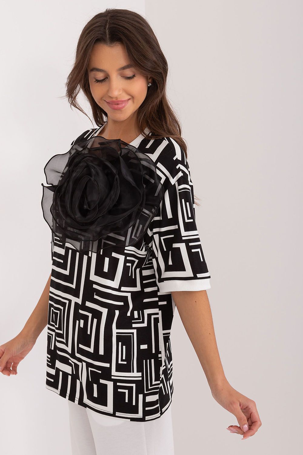 Chic and comfortable short-sleeve viscose blouse by Lakerta, embellished with a floral brooch for added elegance and charm.