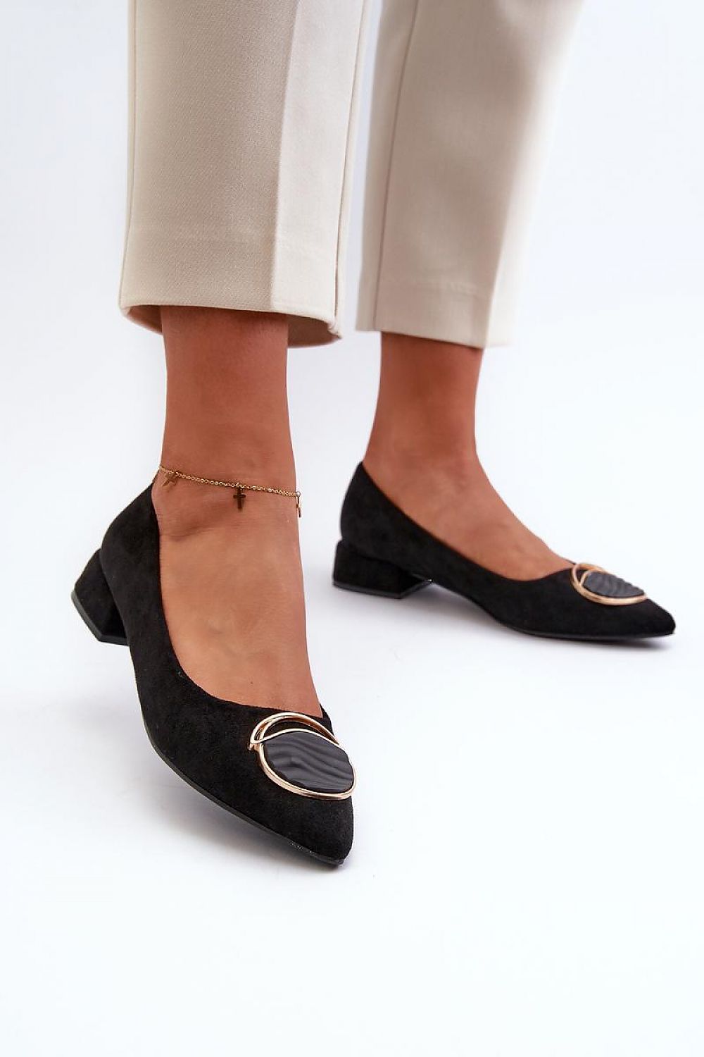 Close-up of Step in Style's elegant eco-suede heel pumps, showcasing the intricate front ornament and refined design, ideal for elevating any outfit.