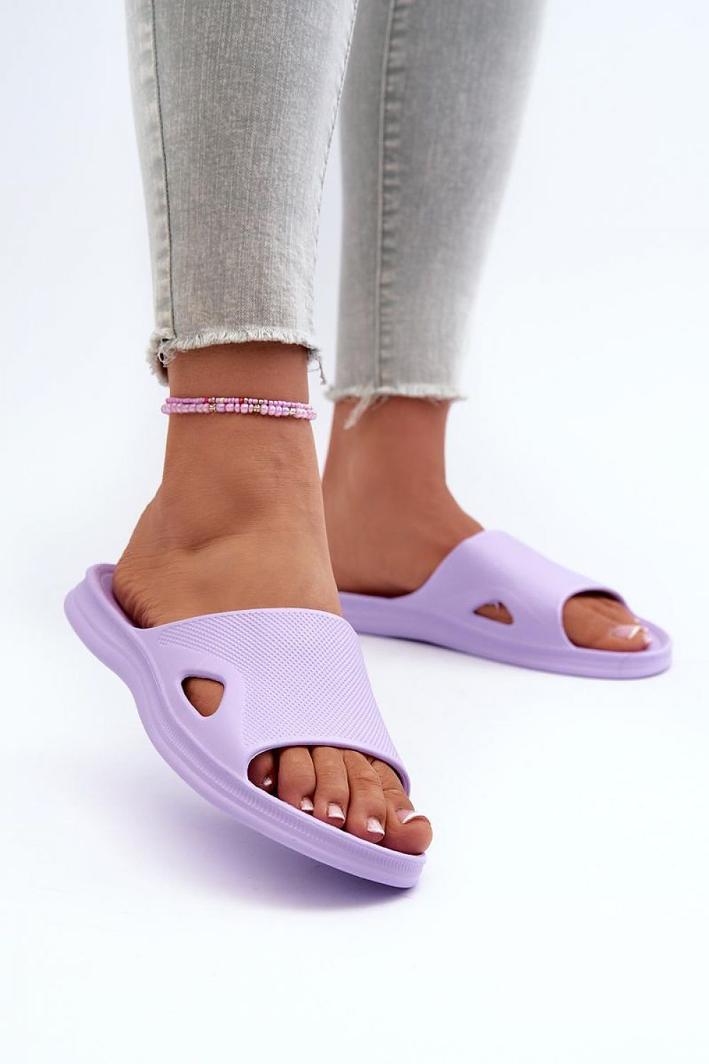 Chic women's foam flip-flops designed by Step in Style, showcasing a minimalist look ideal for coastal vacations, emphasizing comfort and style.