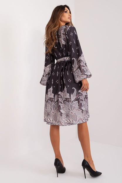Close-up of the stylish print on Lakerta's elegant midi cocktail dress with long sleeves and heart neckline, showcasing its exquisite design and fabric quality.