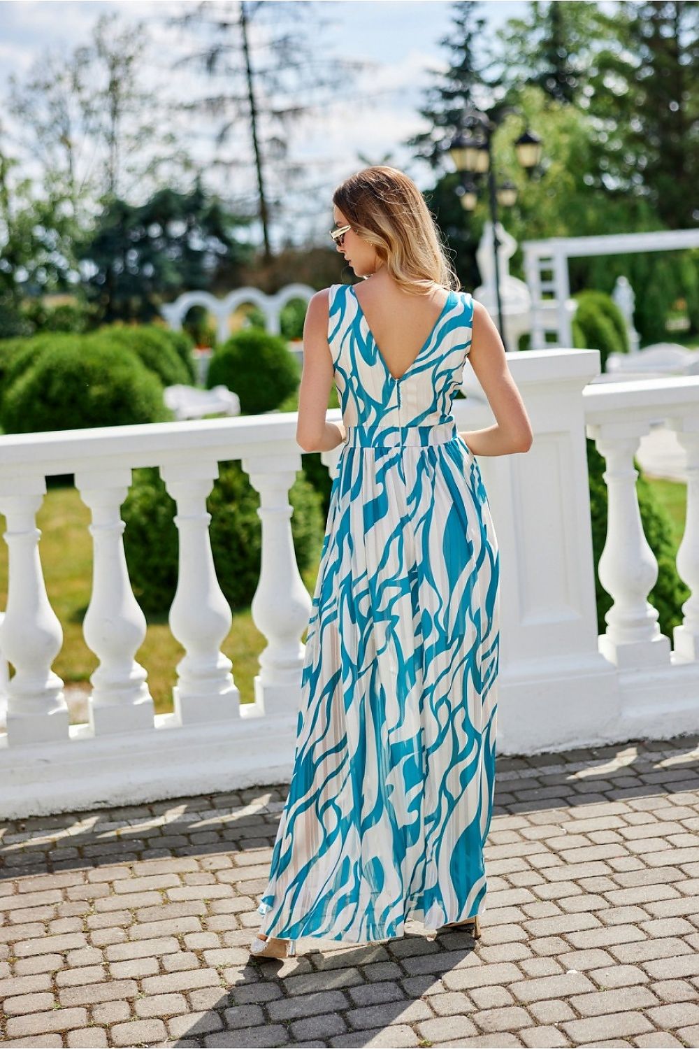 Elegant maxi chiffon dress with cutout back and leg slit by Roco Fashion, showcasing delicate fabric drapes and sophisticated design.