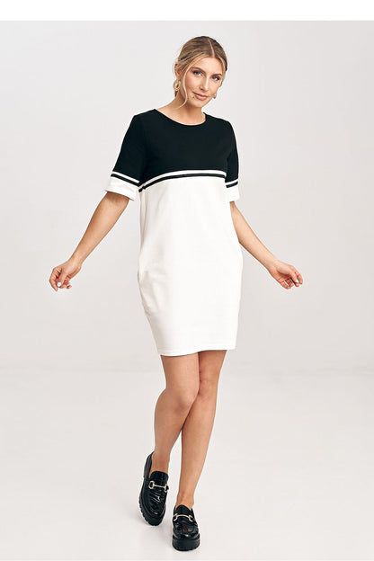 Model wearing the elegant two-tone cotton mini dress by Figl, highlighting its flattering fit and chic everyday versatility.