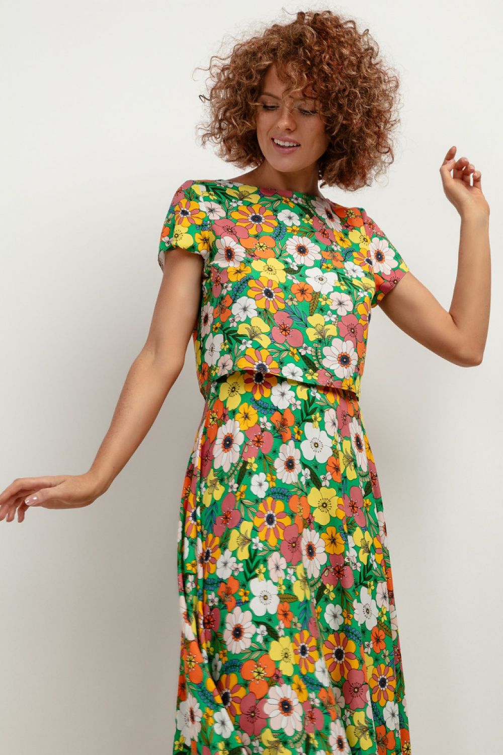 Flat lay of the Tessita T408 viscose blouse displaying its vibrant pattern, ideal for adding a splash of luxury to your summer wardrobe.