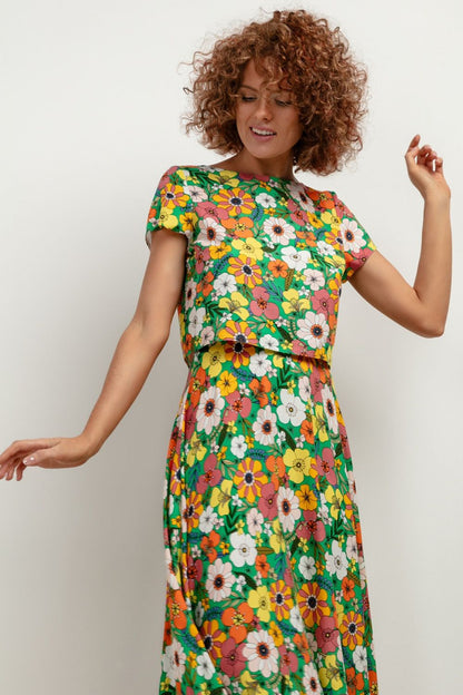 Flat lay of the Tessita T408 viscose blouse displaying its vibrant pattern, ideal for adding a splash of luxury to your summer wardrobe.