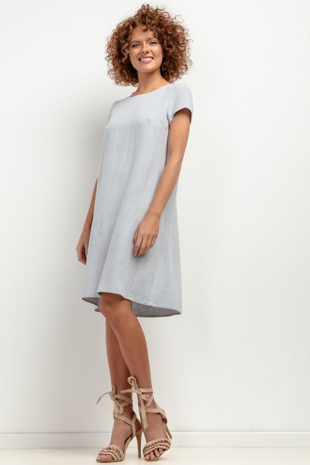Linen T403 dress by Tessita shown in an elegant summer setting, showcasing its loose, lightweight design perfect for warm weather.