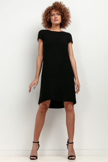 Full-length view of the T403 linen dress by Tessita, accentuating its classic cut and airy silhouette for summer occasions.