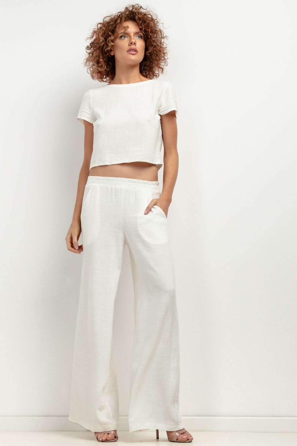 Elegant T404 linen trousers by Tessita featuring a sophisticated wide-leg design, perfect for summer wear, showcasing breathable comfort and luxury style.