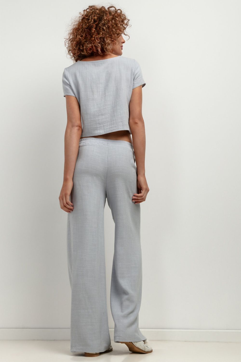 Stylish women wearing Tessita T404 Linen Trousers, epitomising summer elegance and fashionable comfort.