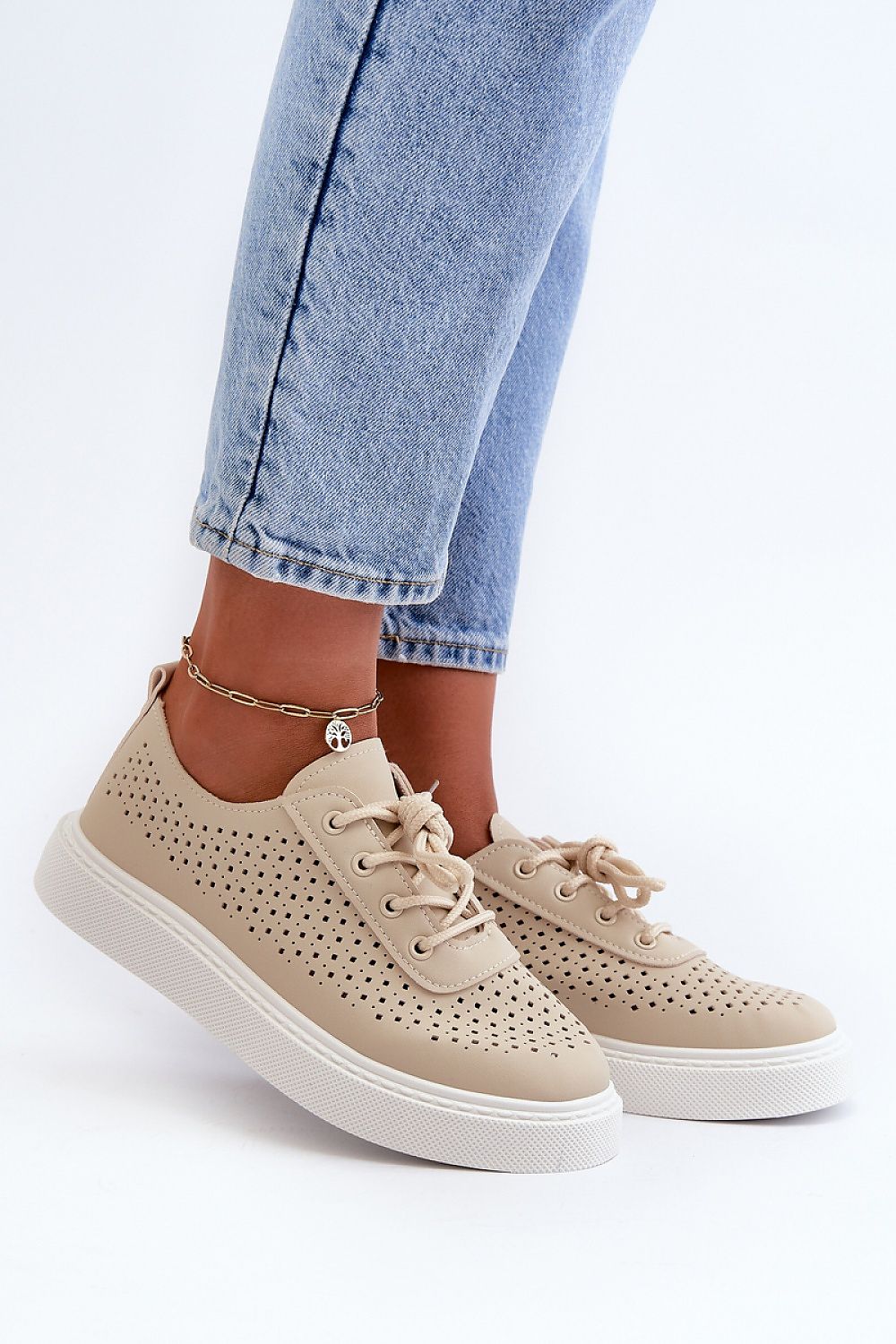 Luxury women's eco leather sneakers with openwork upper and soft foam insole by Step in Style, displayed in an elegant lifestyle setting.