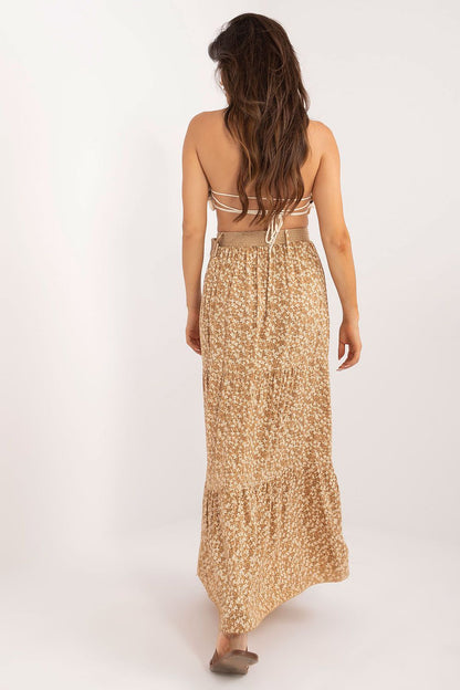 Full-length image of a model wearing the Italy Moda Floral Print Maxi Skirt with ruffle hem, accentuated by a stylish buckled belt, presenting a perfect blend of elegance and comfort for everyday outings.