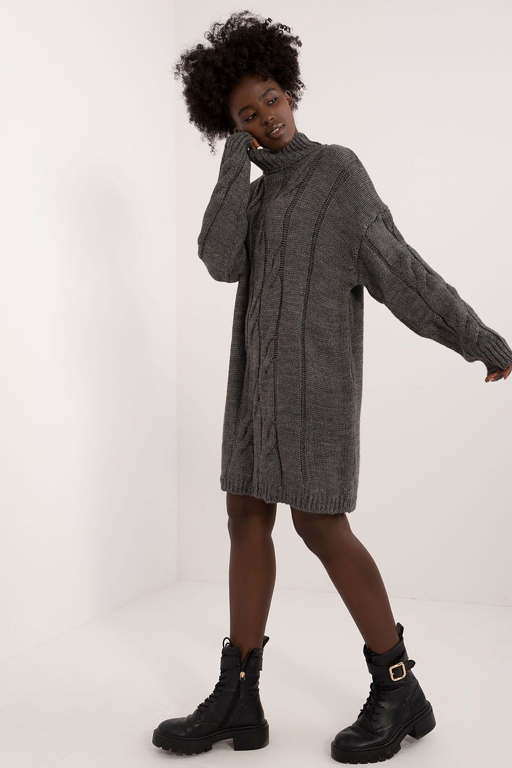 Badu's sophisticated turtleneck dress featuring unique texture and above-the-knee design, suitable for both casual and professional occasions.