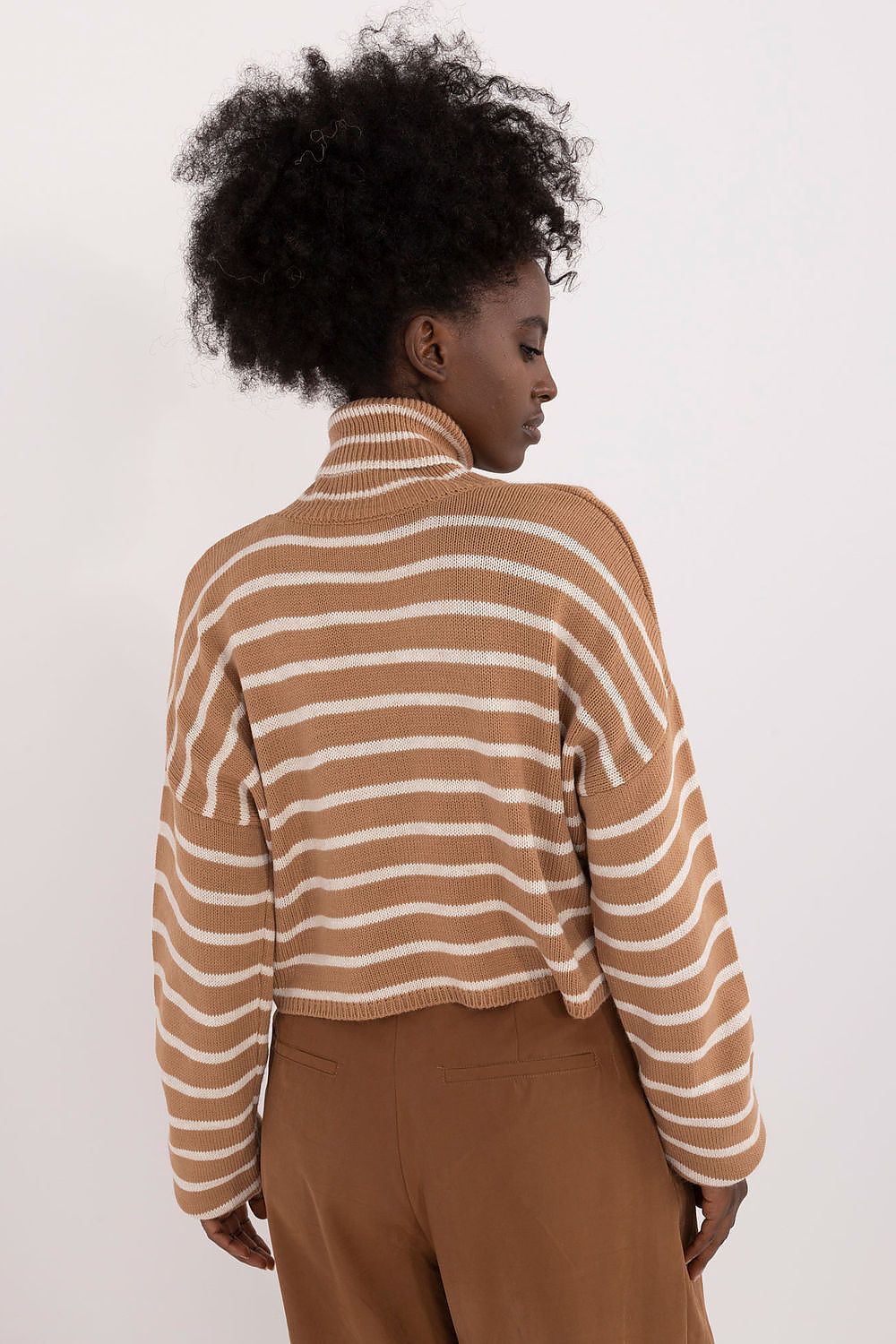 Model wearing Badu's luxury women's striped turtleneck sweater, styled for a chic and sophisticated everyday look.