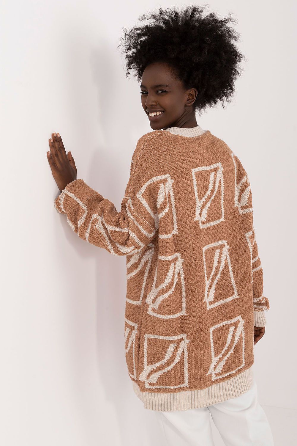 Chic long-sleeve women's sweater by Badu, designed with a flattering extended cut and round neckline.