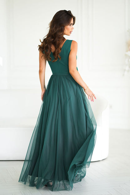 Sophisticated long dress by Bicotone featuring a luxurious rose belt, embodying elegance and versatility for any occasion.