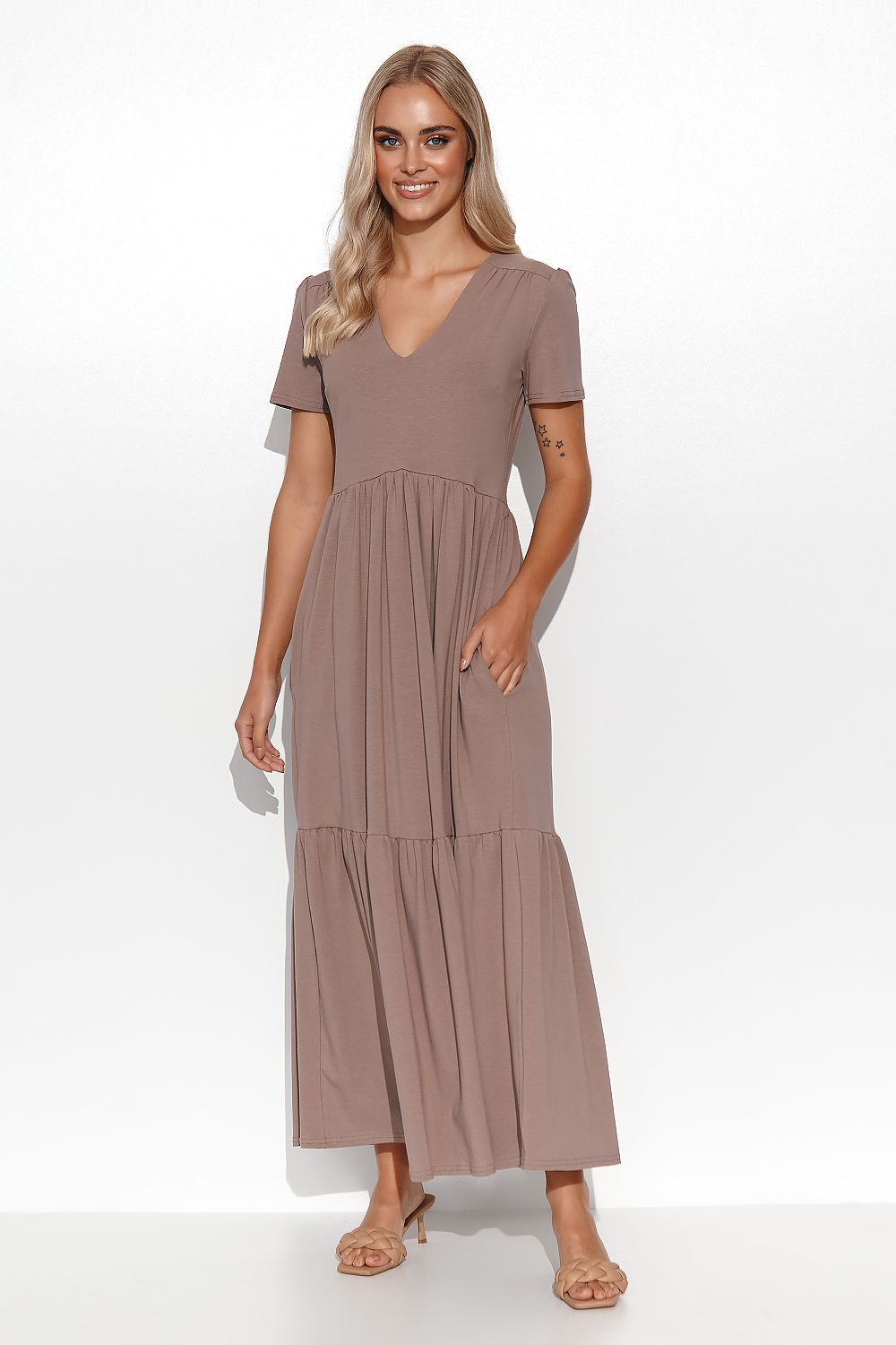Elegant Makadamia Maxi Dress with Ruffles and V-Neckline displayed on a hanger, emphasising its timeless design and elegance.