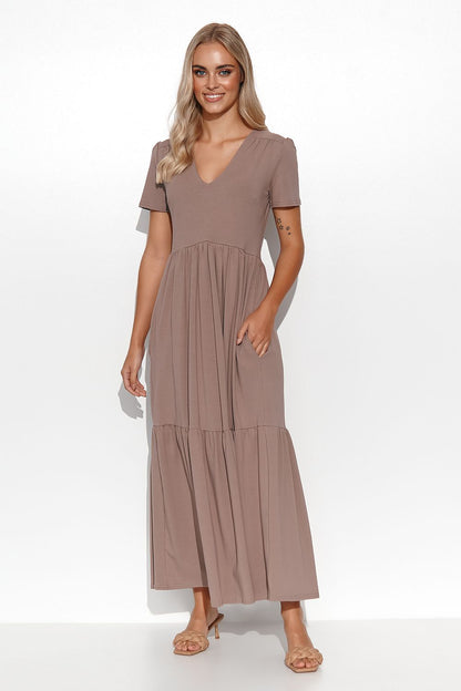 Elegant Makadamia Maxi Dress with Ruffles and V-Neckline displayed on a hanger, emphasising its timeless design and elegance.
