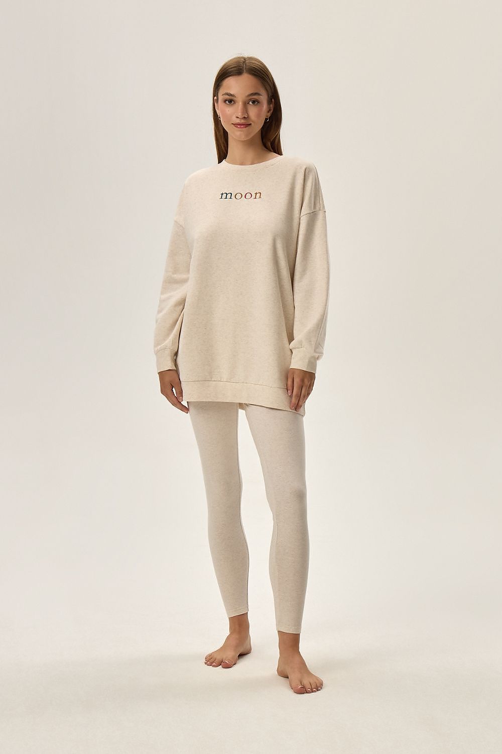 Luxury Henderson Fune Beige Loungewear Set featuring a comfortable top with print and ankle-length leggings, perfect for stylish relaxation.