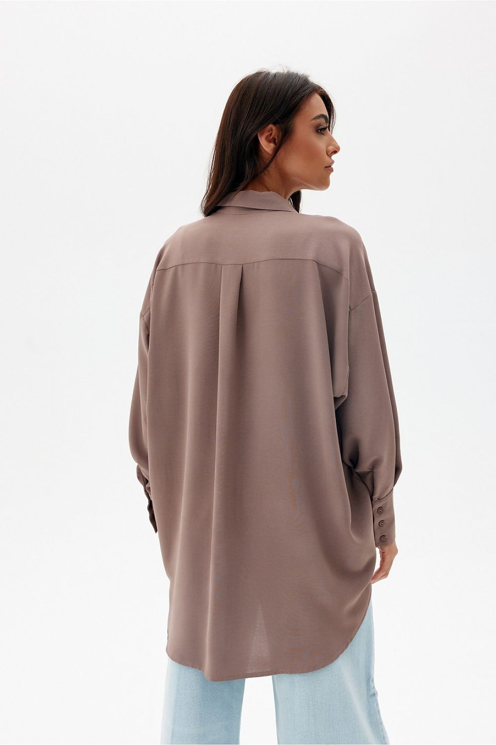 Elegant oversized long sleeve shirt with asymmetrical hem and pocket by Roco Fashion, showcasing a sophisticated design with a traditional collar and longer back.