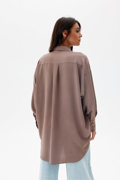 Elegant oversized long sleeve shirt with asymmetrical hem and pocket by Roco Fashion, showcasing a sophisticated design with a traditional collar and longer back.