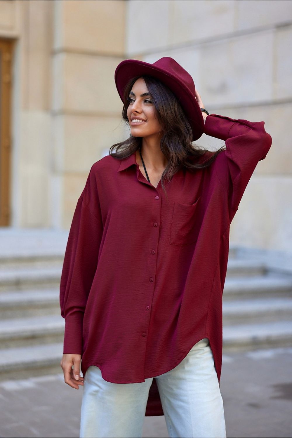 Elegant oversized long sleeve shirt by Roco Fashion featuring an asymmetrical hem and stylish front pocket, perfect for a chic casual look.