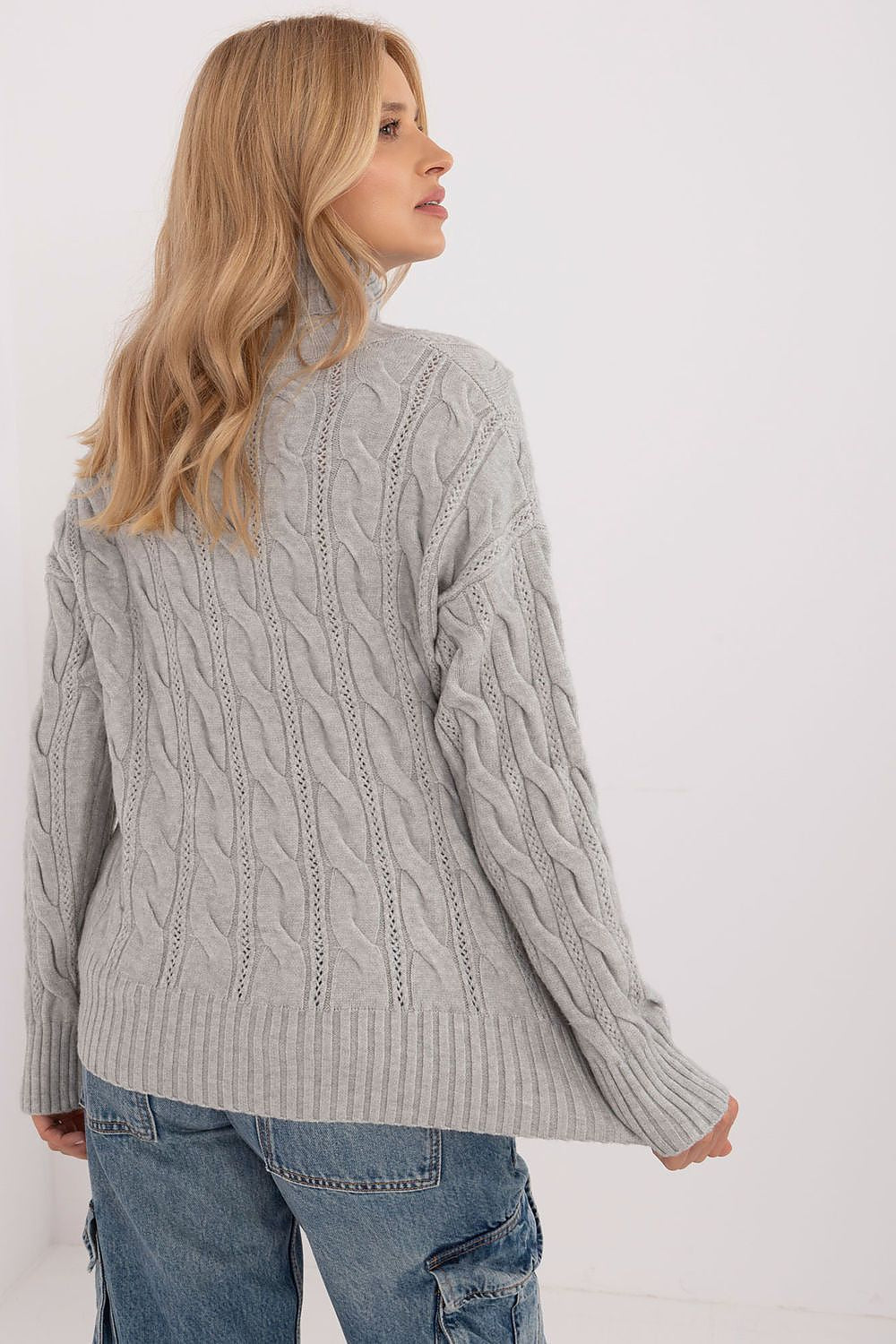 AT's Turtleneck Sweater elegantly draped, highlighting its standard length and long sleeves, a quintessential piece for luxurious winter attire.