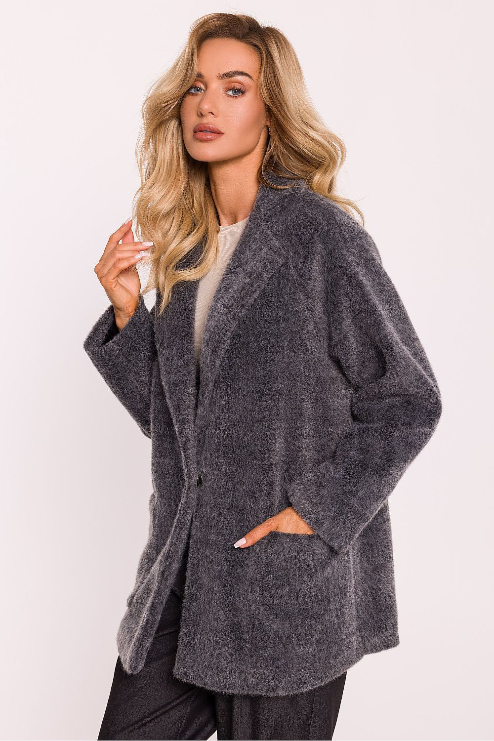 Luxurious oversized teddy bear coat for women by Moe, featuring decorative snap closure and sewn pockets, fully lined for comfort; ideal for cooler weather, crafted in Poland.