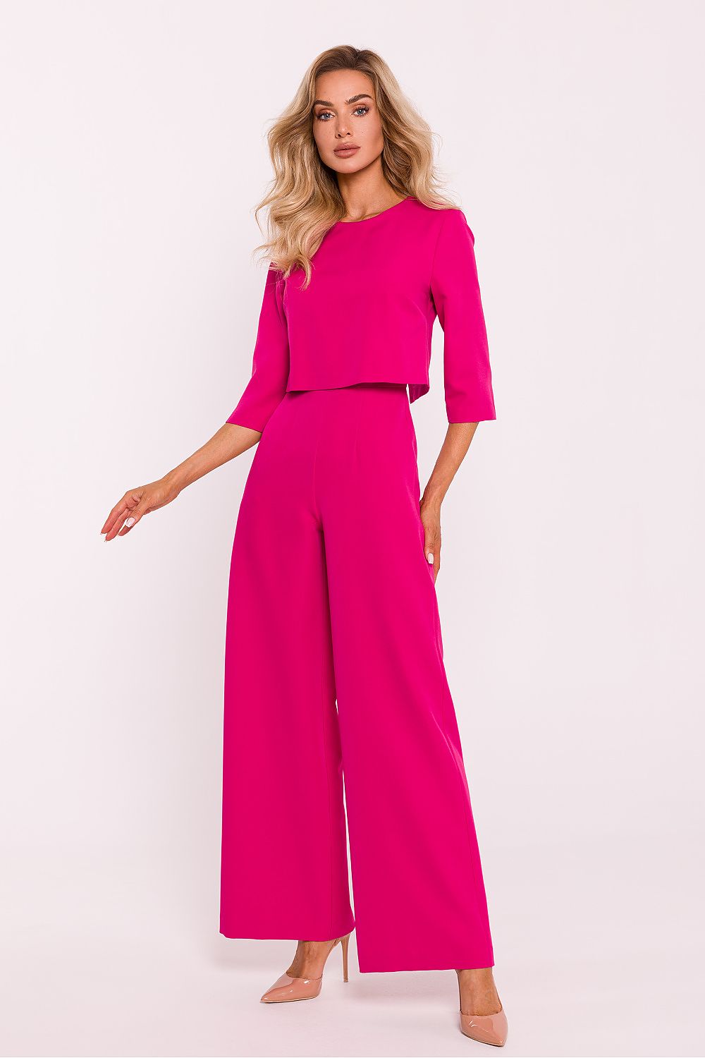 Elegant women's jumpsuit by Moe featuring wide legs, a double-layered top, and practical side pockets, perfect for luxurious style and comfort.