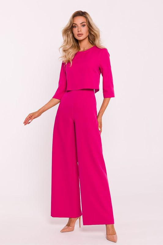 Elegant women's jumpsuit by Moe featuring wide legs, a double-layered top, and practical side pockets, perfect for luxurious style and comfort.